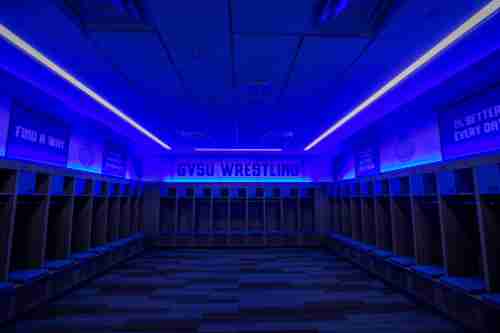 The wrestling locker room, dramatically lit with GVSU blue.